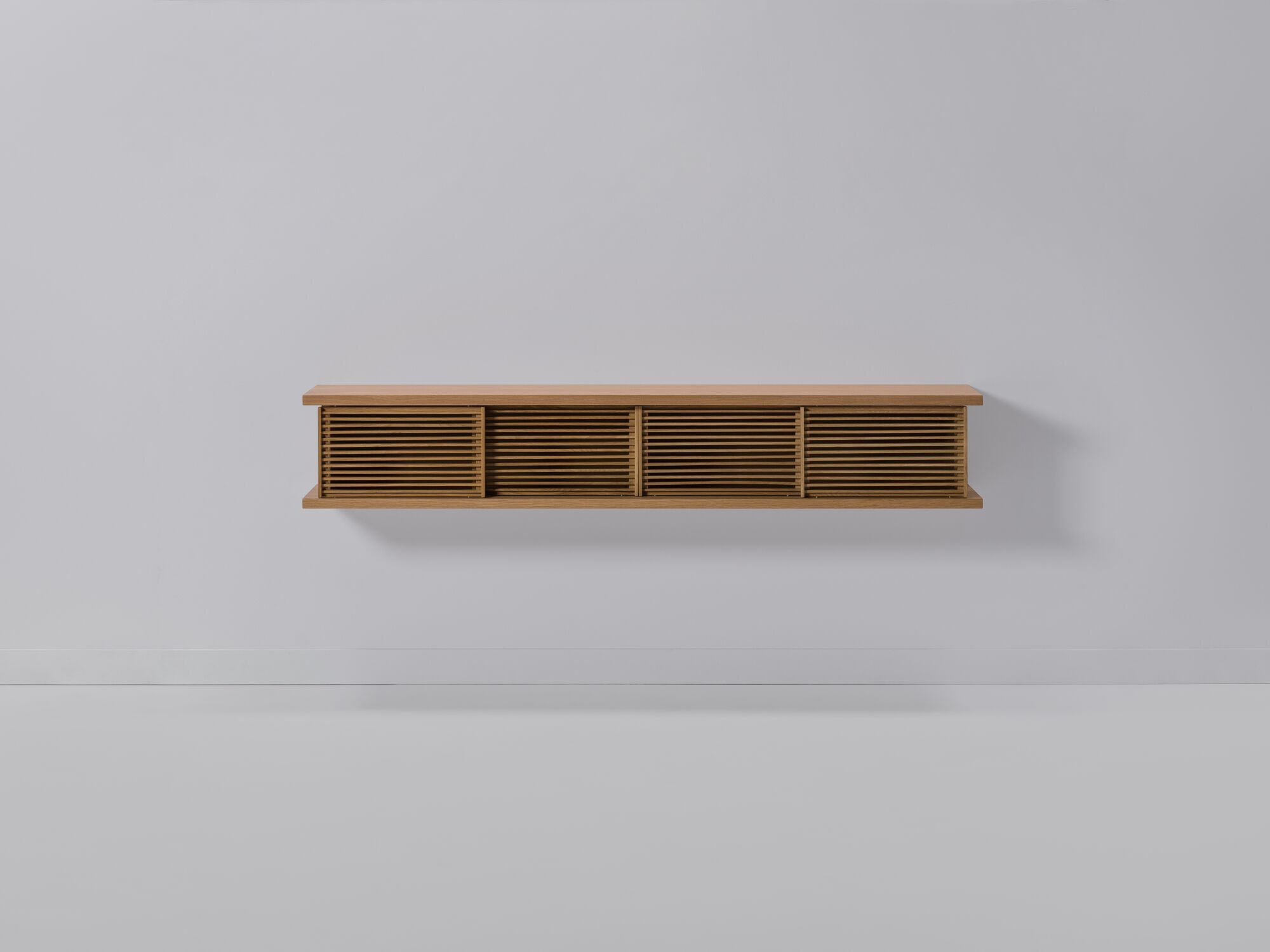 Front view of medium oak floating media unit with slatted doors